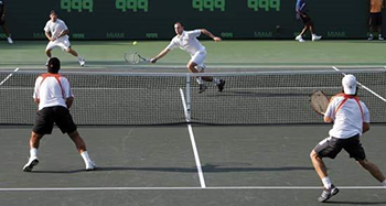 4 men playing a Men's Doubles tennis match